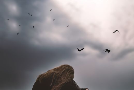 girl teenager student lonely upset by the sky with birds thinks about a difficult life tragedy. High quality photo