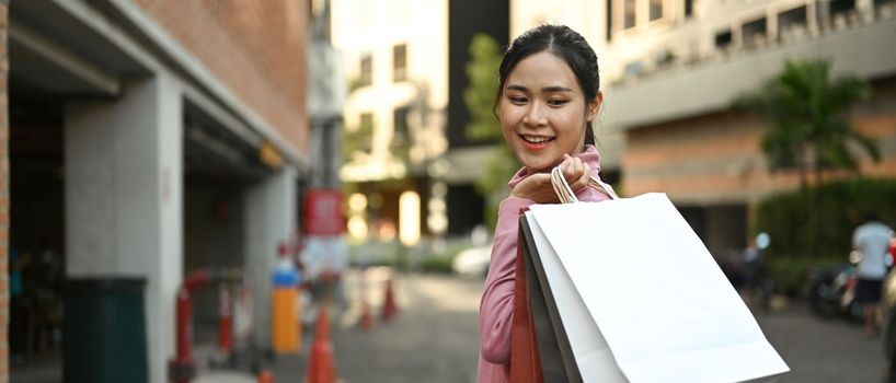 Panoramic view of fashionable woman carrying shopping bags. Sale, holiday vacation activity lifestyle concept.