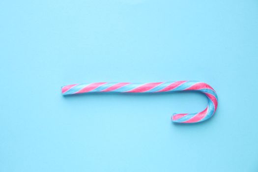 Candy cane on a blue background. Merry Christmas card. .