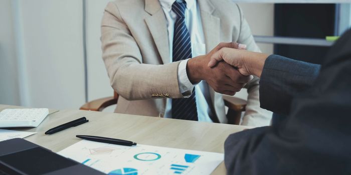 Business partnership handshake concept.Photo two coworkers handshaking process.Successful deal after great meeting.