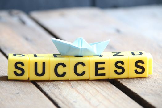 Success creative concept. Lettering from yellow cubes.