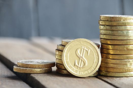 Business graph made of coins on a wooden background.