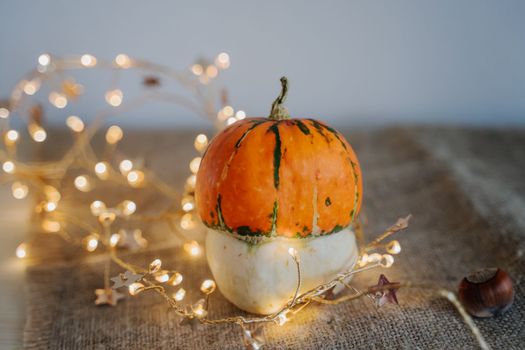 Pumpkin and nuts. Yellow lanterns. Bokeh. Thanksgiving Day. Festive composition.