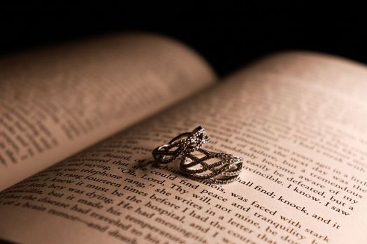 Rings sitting on a book low light. High quality photo