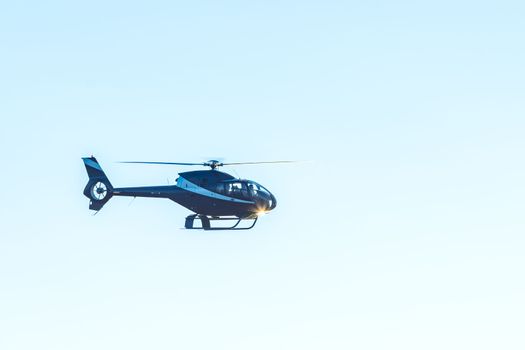 helicopter flying in the blue sky. High quality photo