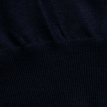 Knitted elastic band on navy wool sweater background close up