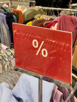 red and white percent sale sign in store mobile photo. High quality photo