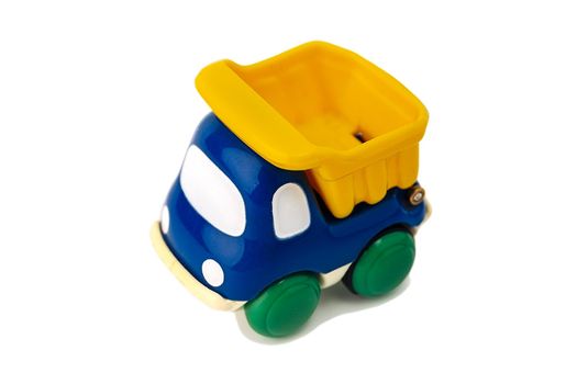 Toy children's dump truck isolated on a white background. Kids toy dump truck. Plastic children's toy. close-up. space for copying. High quality photo