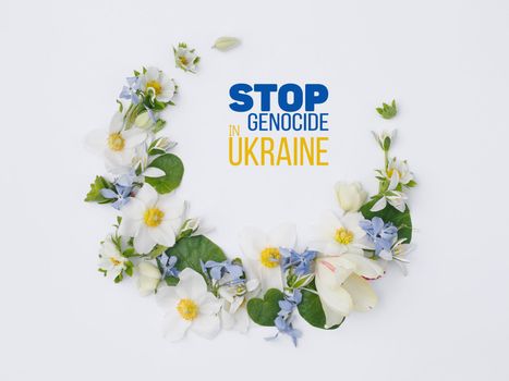 spring flowers on white background lie in the form of month with words stop genocide in ukraine. concept needs help and support, truth will win