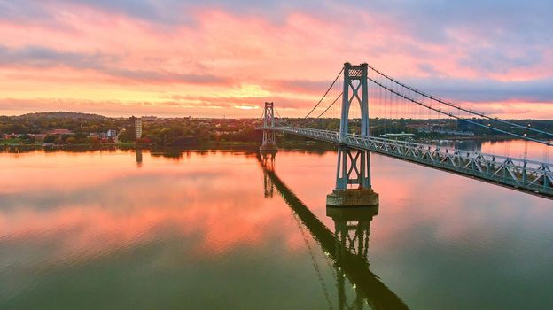 Image of Aerial golden hour sunrise over stunning American New York bridge with pink light