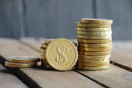 Business graph made of coins on a wooden background.