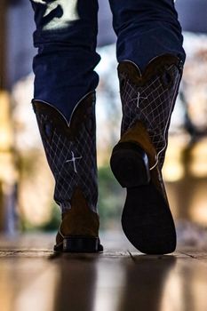 Man walking in cowboy boots. High quality photo