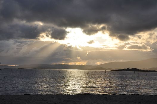 rays of light breaking through stormy clouds.