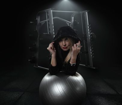 Strong woman doing weights.Sports lifestyle Beautiful fitness woman lifting dumbbells . Fitness sporty woman showing her well trained body. A beautiful girl's body with rippling muscles from strength training. High quality photo