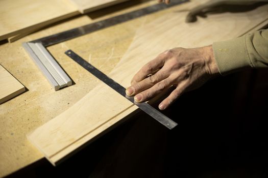 Part markup. Furniture design. Hand holds ruler. Tagging. Carpenter at work.