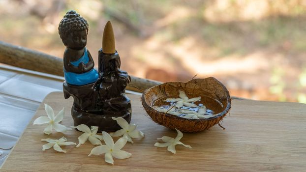 buddha figurine in meditation with incense sticks. High quality photo