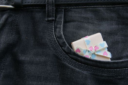 Gift in jeans pocket. High quality photo.