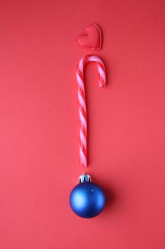 Merry Christmas creative card. Candy cane and Christmas Bauble.