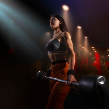 Strong woman doing weights.Sports lifestyle Beautiful fitness woman lifting dumbbells . Fitness sporty woman showing her well trained body. A beautiful girl's body with rippling muscles from strength training. High quality photo
