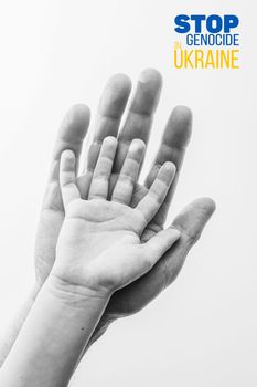 male hand hold children on white background with words stop genocide in ukraine black and white color. concept needs help and support, truth will win