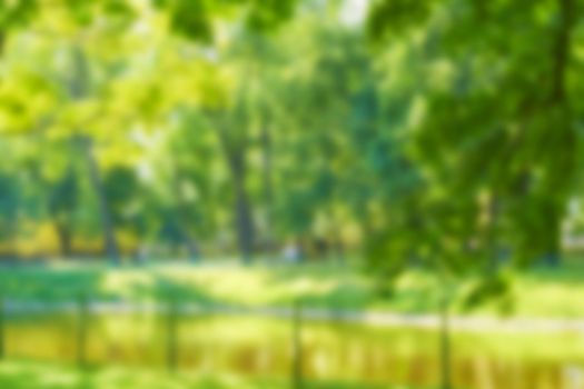 Blur natural and light background in the park. Abstract blur image of Green garden on day time with bokeh for background usage. Bokeh light yellow green abstract backgrounds textures. High quality photo