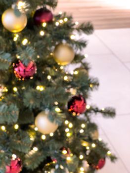 blurred decorated christmas tree in shopping mall background. High quality photo