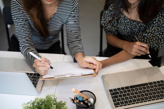 Cropped shot two creative women working together in office.