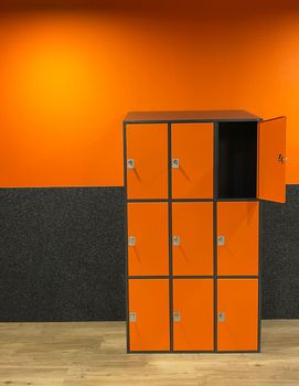 dressing room in the gym with orange-gray cement walls locker room for athletes. High quality photo
