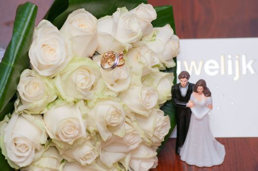 wedding bouquet of light lemon roses with rings moto biker wedding. High quality photo