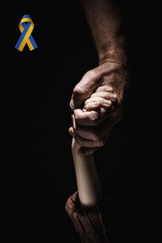male hands hold childrens in the dark background. concept needs help and support, truth will win