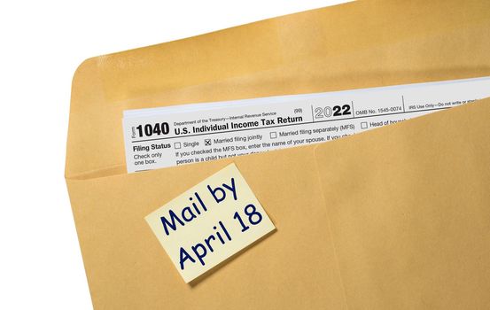 Printed copy of Form 1040 for income tax return for 2022 with reminder for April 18 2023 deadline