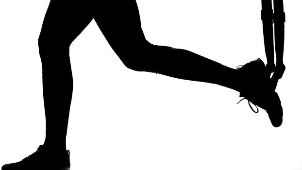 on a white background, a shadow, a black outline of a female figure doing exercises. High quality photo