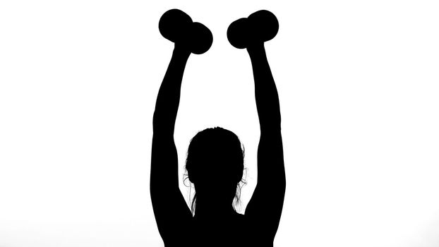 on a white background, a shadow, a black outline of a female figure doing exercises for the muscles of the hands, using dumbbells. High quality photo