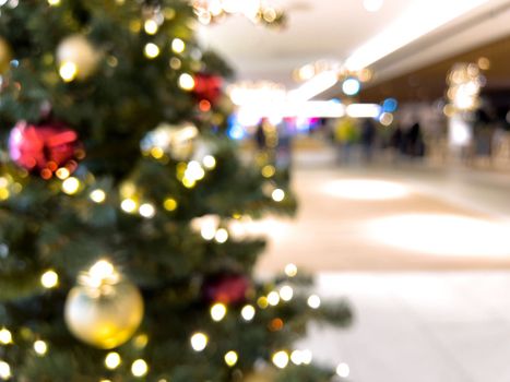 blurred decorated christmas tree in shopping mall background. High quality photo