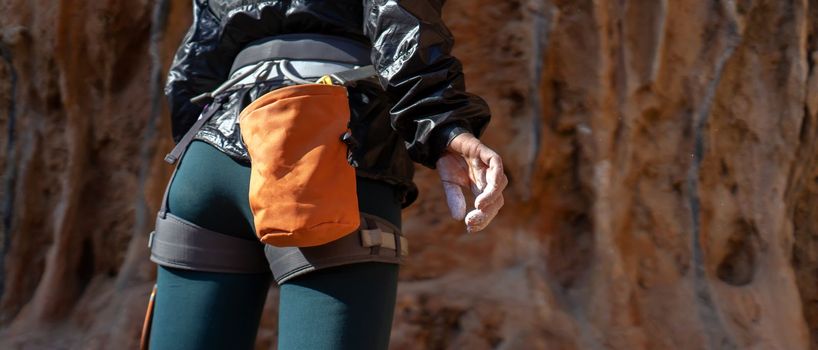 The hand of a young girl with white powder, magnesia close-up, a woman is engaged in active sports, prepares for training, for outdoor climbing.