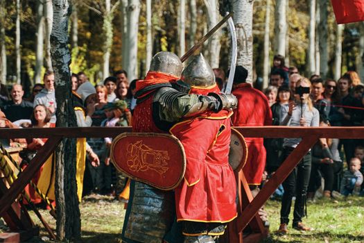 Two knights embrace each other as a sign of respect. Festival of jousting tournaments. Simulation of medieval battles during the festival of historical clubs. Bishkek, Kyrgyzstan-October 13, 2019.