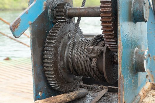 Stretching a steel cable on a flywheel on a ship. High quality photo