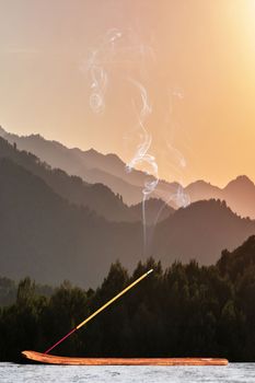 Burning incense stick in the mountains of Tibet. Vertical Comosition with copy space.