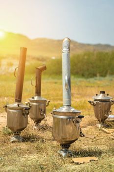 Boiling samovar in the steppe, Catering travel outdoor, copy space, vertical.