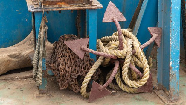 Anchor with a rope on the deck of a sea vessel. High quality photo