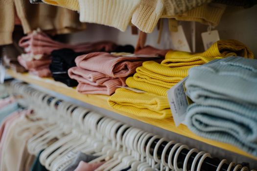 Clothing store. Sale of clothes. Children's clothing and footwear store. Tights for children from pleasant and soft fabric. Pants in blue, pink and yellow.