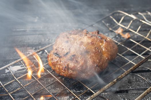 Beef or pork meat barbecue burgers for hamburger prepared grilled on bbq fire flame grill