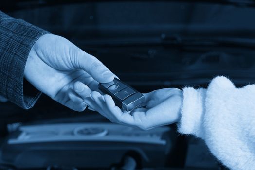 Professional Car Mechanic Giving Client Keys from her Repaired Car In Auto Repair Service