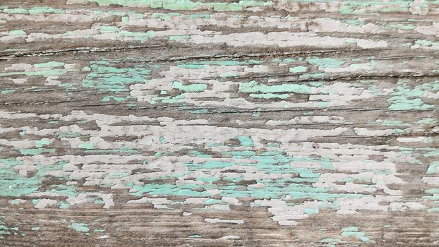Texture of wooden board with cracked paint in pastel tones. Top view