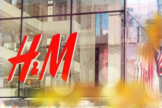 NEW YORK, USA - MAY 15, 2019: close up shot of H M logo. H M Hennes Mauritz AB is a Swedish multinational retail-clothing company, known for its fashion clothing