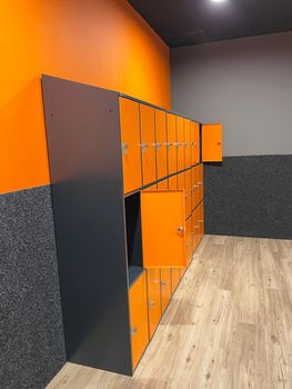 dressing room in the gym with orange-gray cement walls locker room for athletes. High quality photo