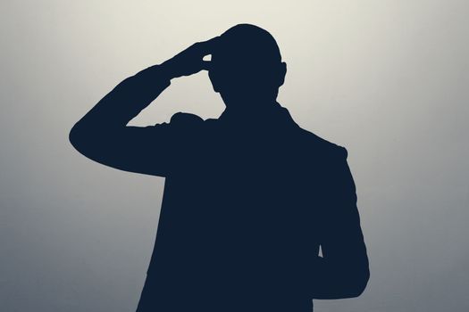 silhouette of man pointing to head with one finger, great idea or thought, good memory