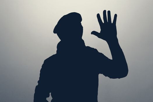 Silhouette of man waving hand in hello gesture. Anonym club concept. You are welcome.