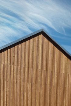 Roof construction with wooden plank gable on a new modern home. Copy space, vertical