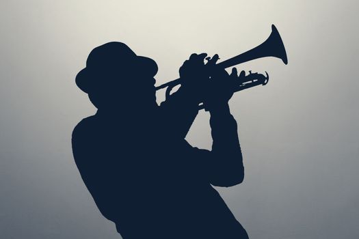 silhouette of a jazz man playing trumpet. High quality photo